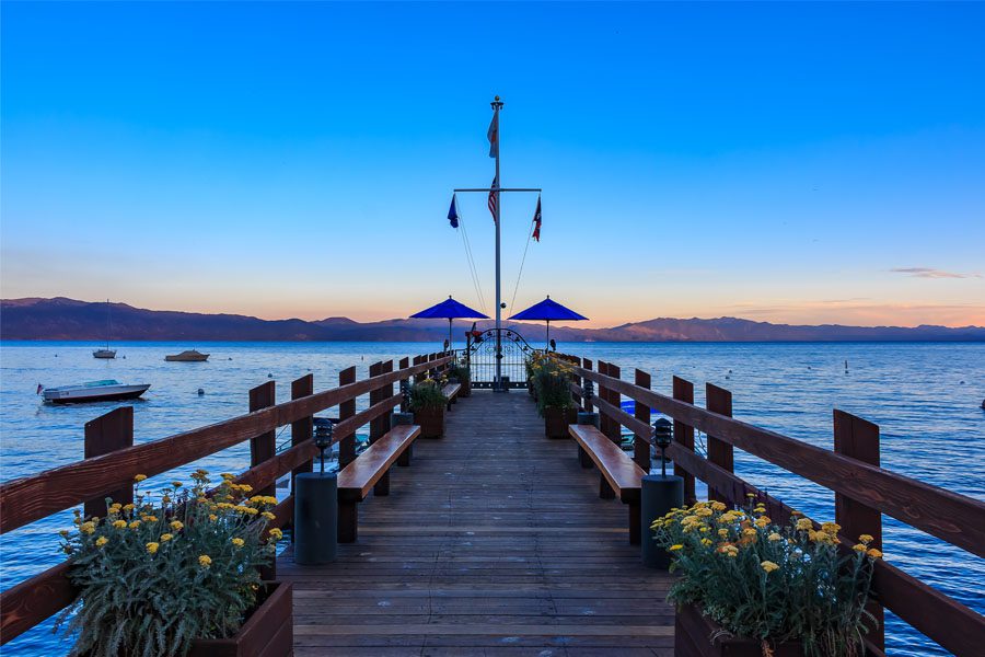 Carnelian Bay, Califronia USA - July 18, 2015: Scenic view onto Lake Tahoe at sunset from an old wooden pier at the Gar Woods Lake Tahoe restaurant